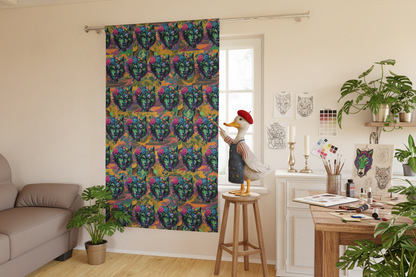 Living room with a colorful curtain featuring a pattern of faces, a table with decor items, and a plant.