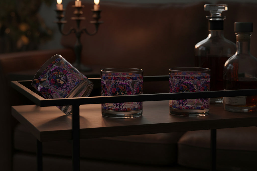 Set of three glass tumblers with colorful designs on a white background