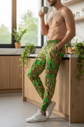 A person wearing unisex green mosaic patterned joggers with double-layered side pockets and an adjustable drawstring.
