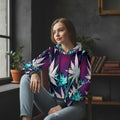 A woman wearing a multicolored cropped hoodie with a geometric pattern featuring stars and leaves.