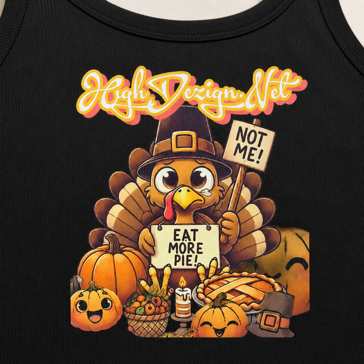 Close-up of a black tank top featuring a colorful cartoon Thanksgiving turkey graphic with pumpkins, a pie, a candle, and the text 'High Design Net' and 'EAT MORE PIE!'.