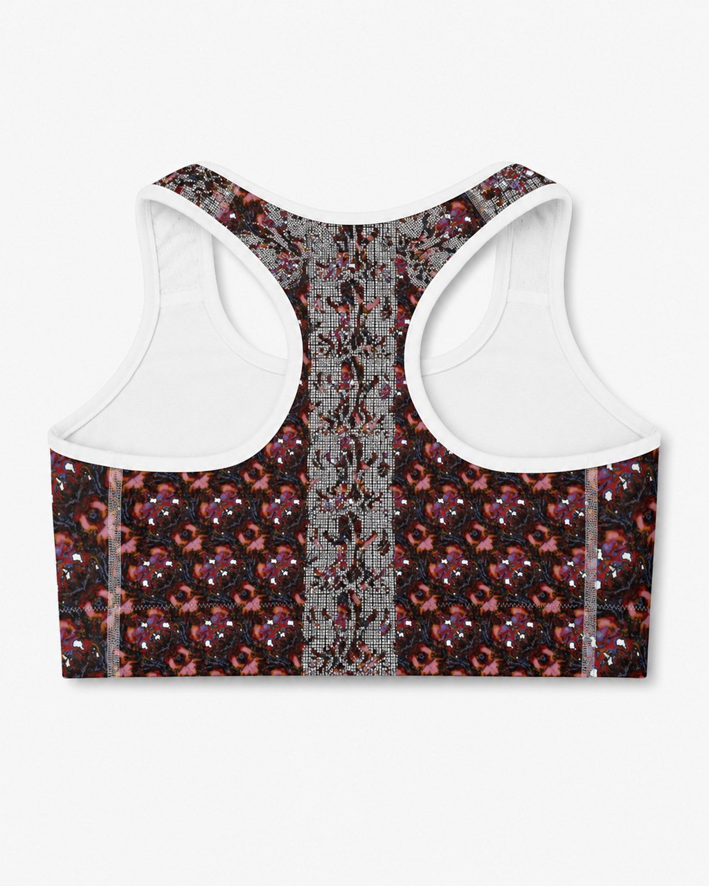 A women's sports bra shown from the back, featuring a black base with a dense red, pink, and gray floral pattern, a central gray patterned panel, and solid white shoulder straps.
