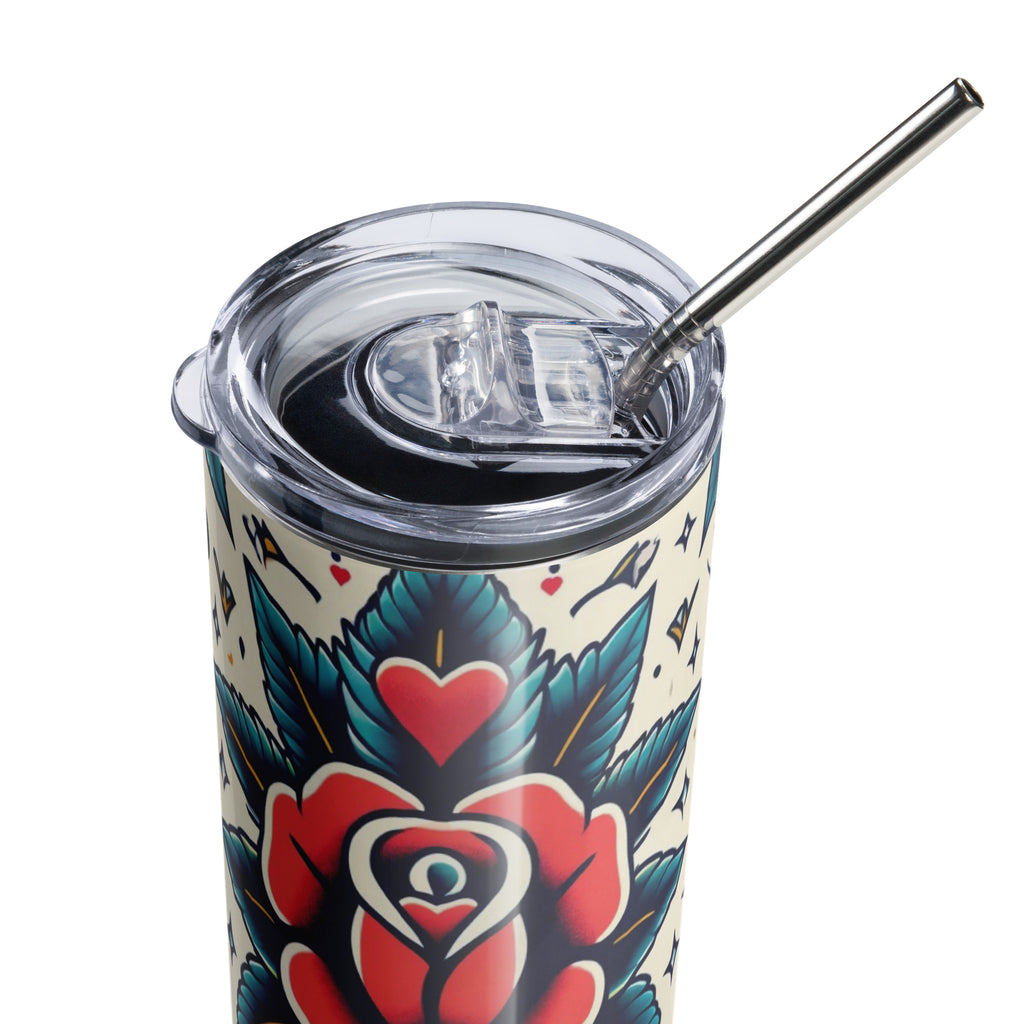 A close-up of a tumbler with a clear lid and metal straw, featuring a traditional tattoo-style floral design in red, teal, black, and cream.