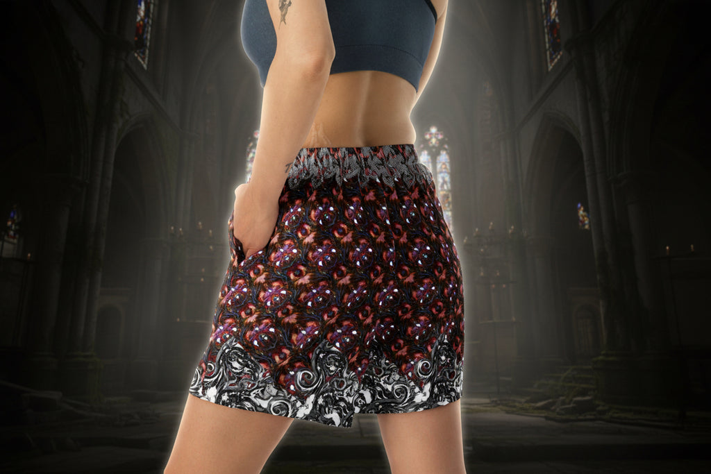 Person wearing a patterned skirt in a dark, cathedral-like setting