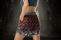 Person wearing a patterned skirt in a dark, cathedral-like setting