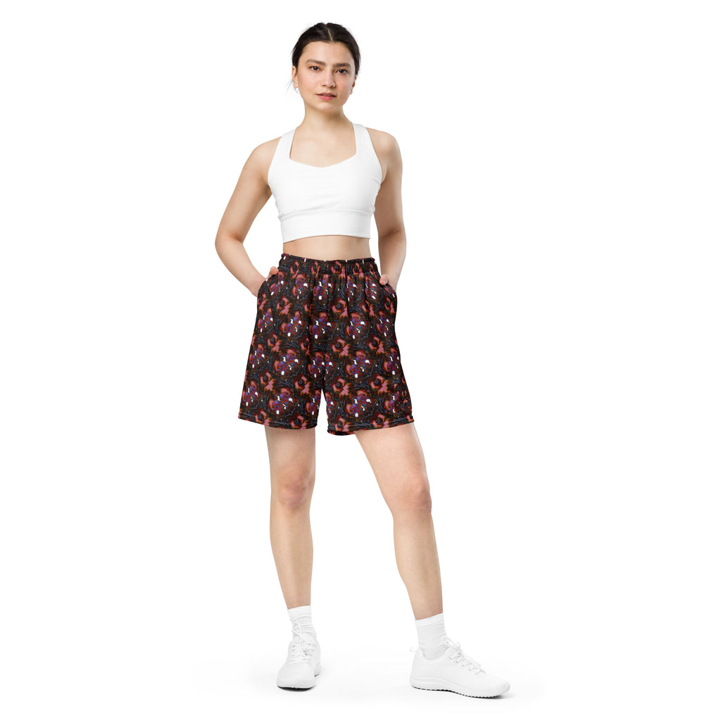 Woman wearing a white crop top and patterned shorts on a white background