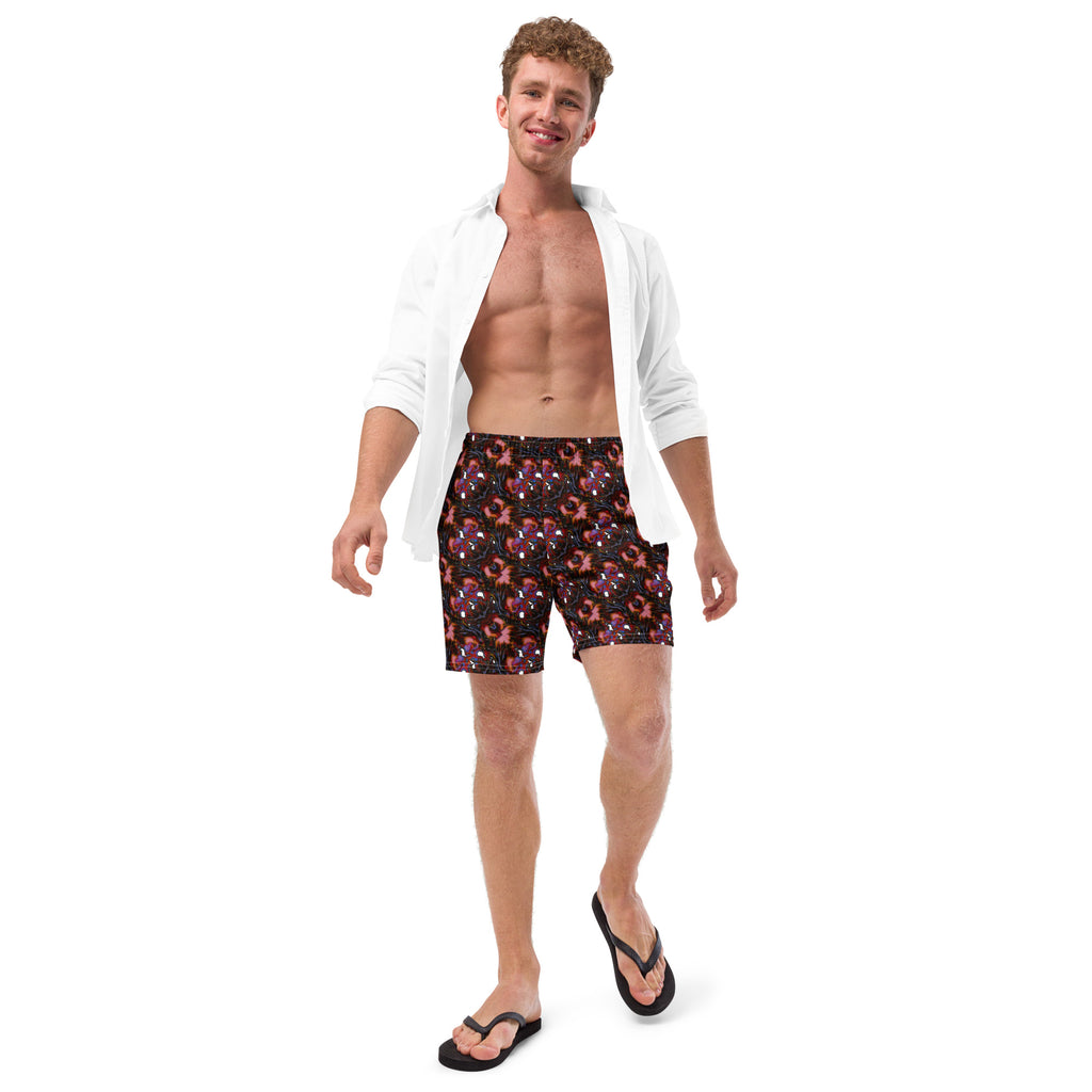 Man wearing red swim shorts with white polka dots and a white shirt on a white background