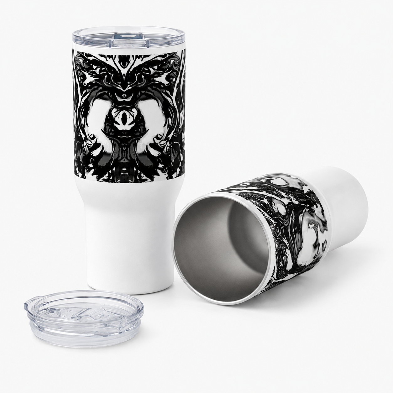 A white insulated travel tumbler with a clear lid, shown upright and on its side to display the interior and the printed black-and-white gothic skull artwork. A clear lid is placed in front on a clean white background.