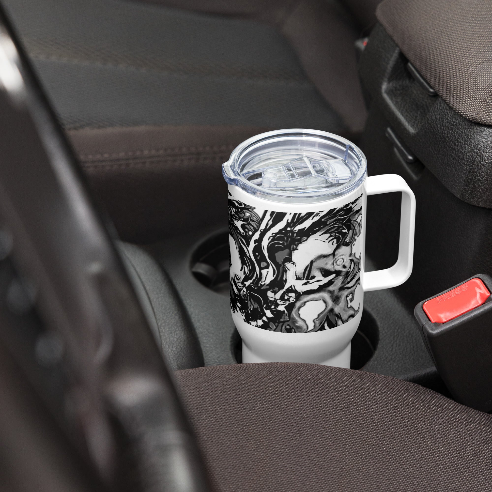 Travel mug with black and white design in a car cup holder