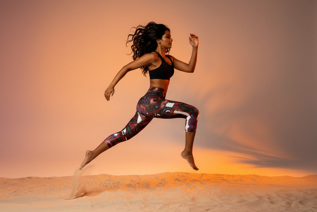 Woman running in a desert landscape with a warm sunset sky
