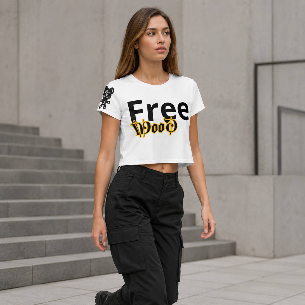 A woman wearing a white cropped t-shirt with 'Free Wood' printed in black and gold gothic lettering, paired with black cargo pants, walking down concrete stairs.