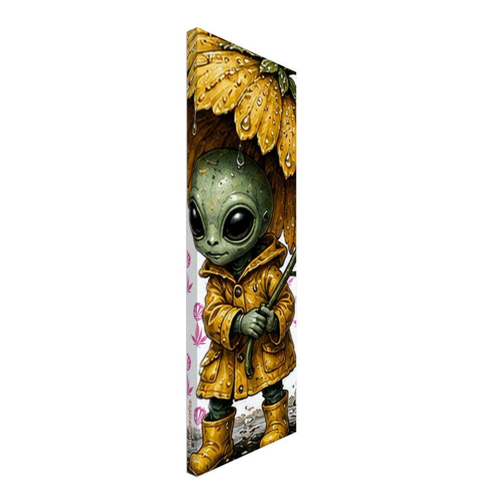 A vertical canvas wall art print featuring a cute green alien character wearing a yellow raincoat and holding a matching yellow umbrella, shown at an angle against a plain white background.