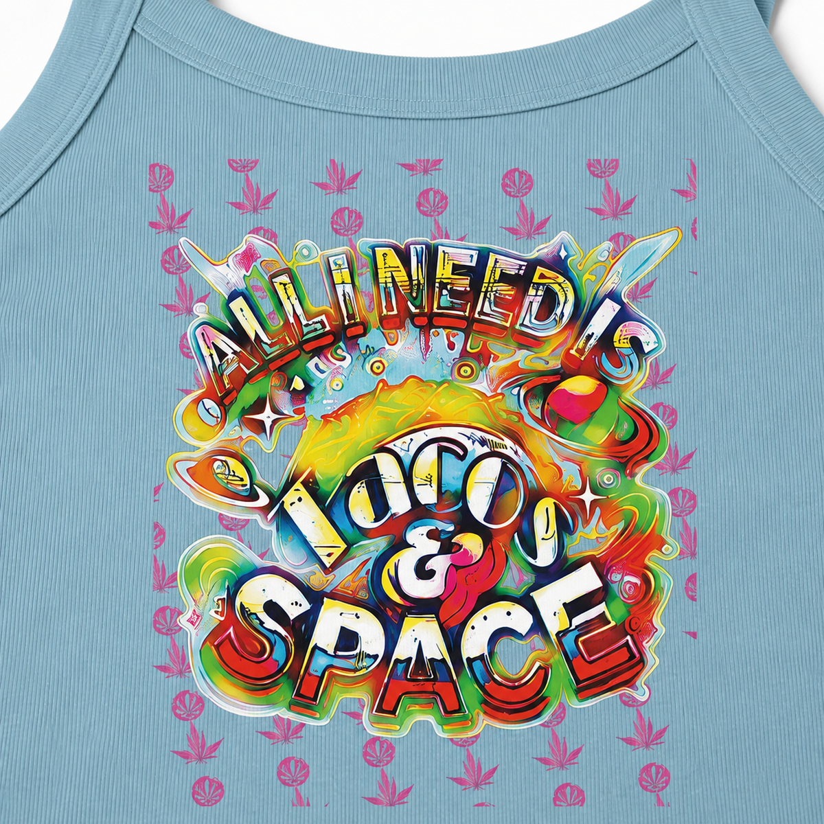 A close-up of a light blue tank top featuring a colorful retro graphic that reads 'ALL IN NEED IS LOCO & SPACE' in bold, multicolored bubble letters. The design includes a retro planet, stars, and a pink leaf pattern in the background.