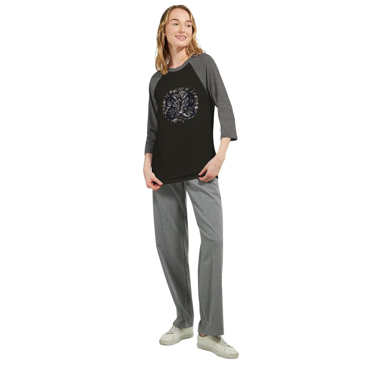 Person wearing a black and gray shirt with 'UNIKAT' branding on a white background