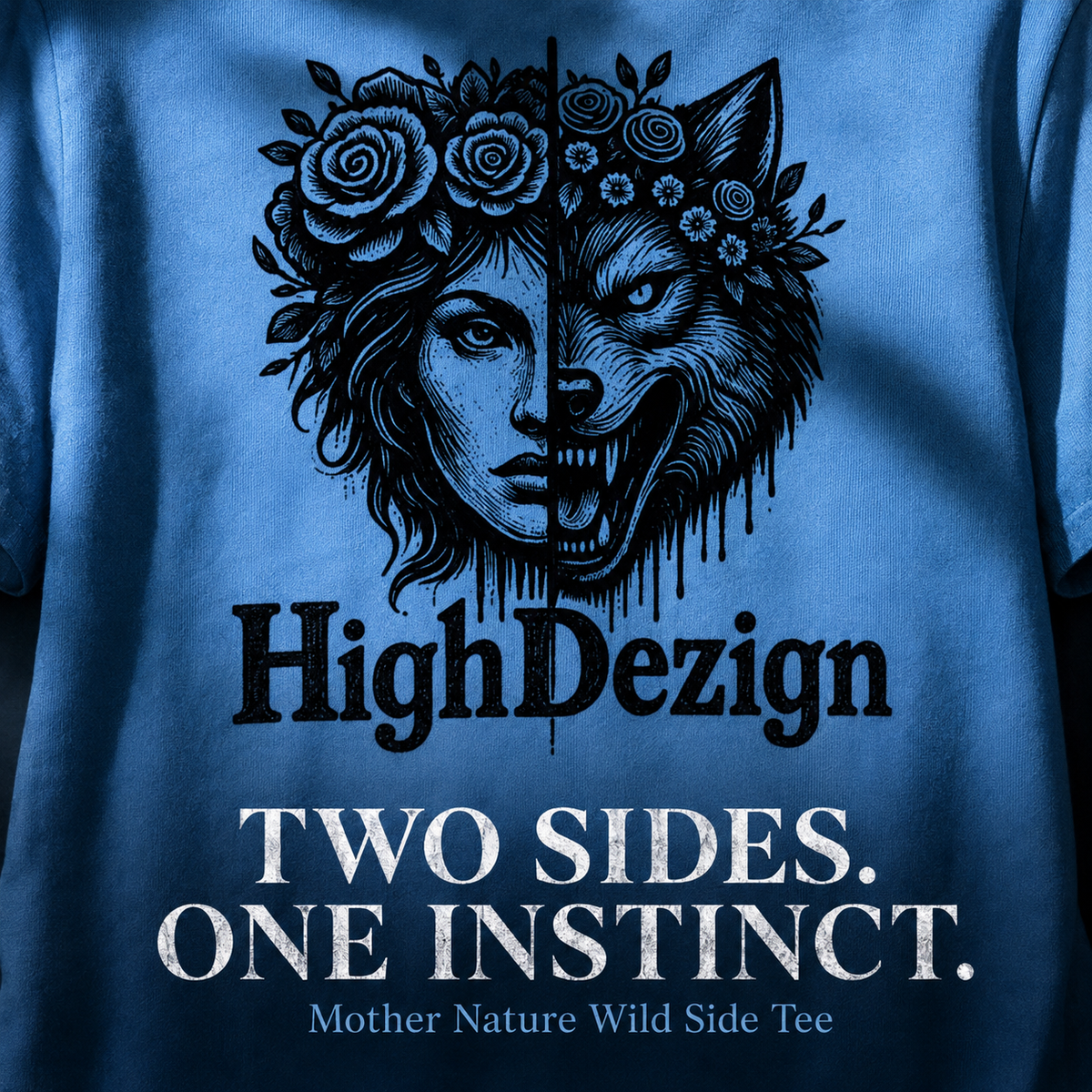 Close-up of a blue graphic t-shirt featuring a split design: a woman's face with a flower crown on one side and a wolf's head on the other. Below the graphic, the text reads 'HighDezign' in black, 'TWO SIDES.