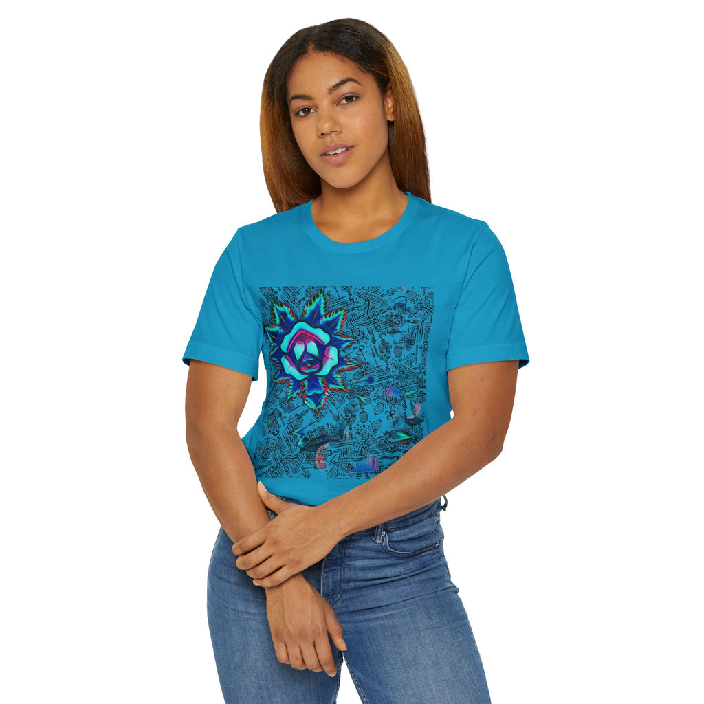 A woman modeling a bright turquoise blue short-sleeve t-shirt with a colorful, detailed mandala-style graphic on the front, paired with blue jeans against a plain white background.