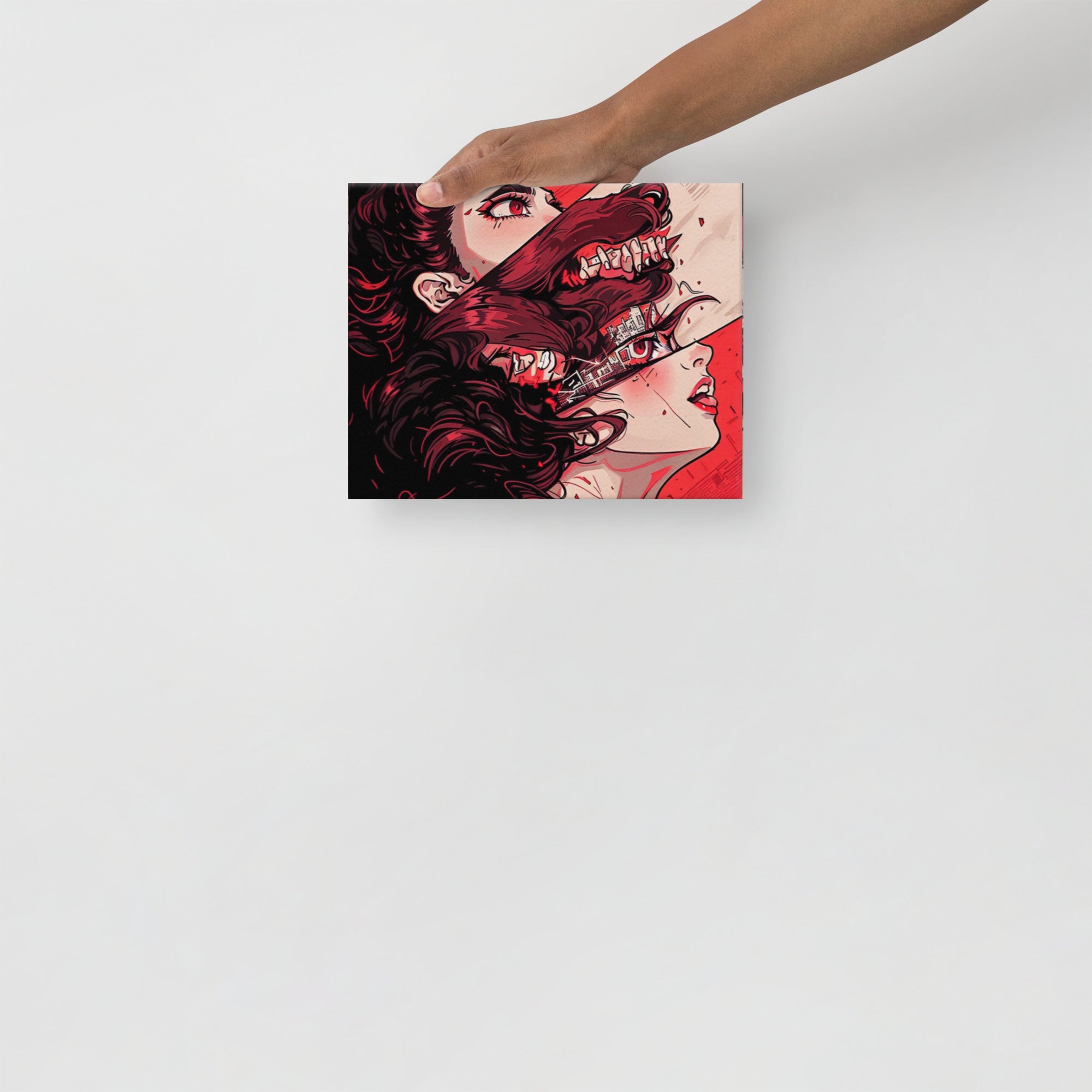 Hand holding a box with a graphic design of a woman with red hair and a creature's face.