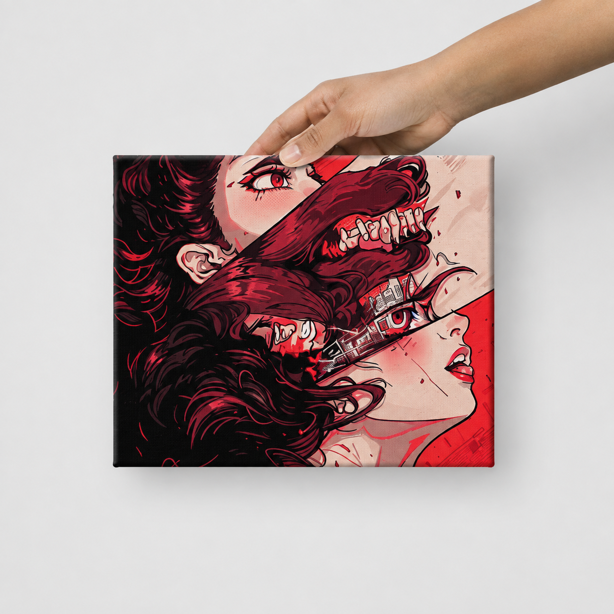 A hand holds a square canvas print featuring a stylized graphic illustration of a woman's face split into red and black tones, with a wolf head emerging from her hair, against a plain light gray background.