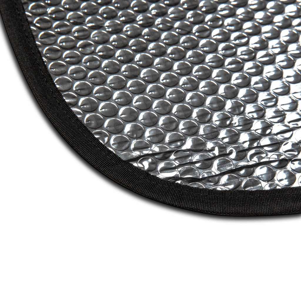 Close-up of a textured silver mat with black border on a white background