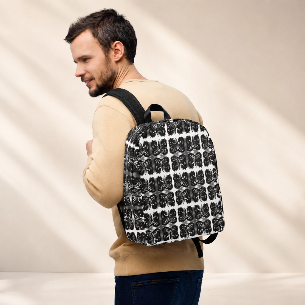A man wearing a beige sweatshirt and blue jeans is shown from the back and side, carrying a black and white patterned backpack with black straps against a warm beige background with soft diagonal shadows.
