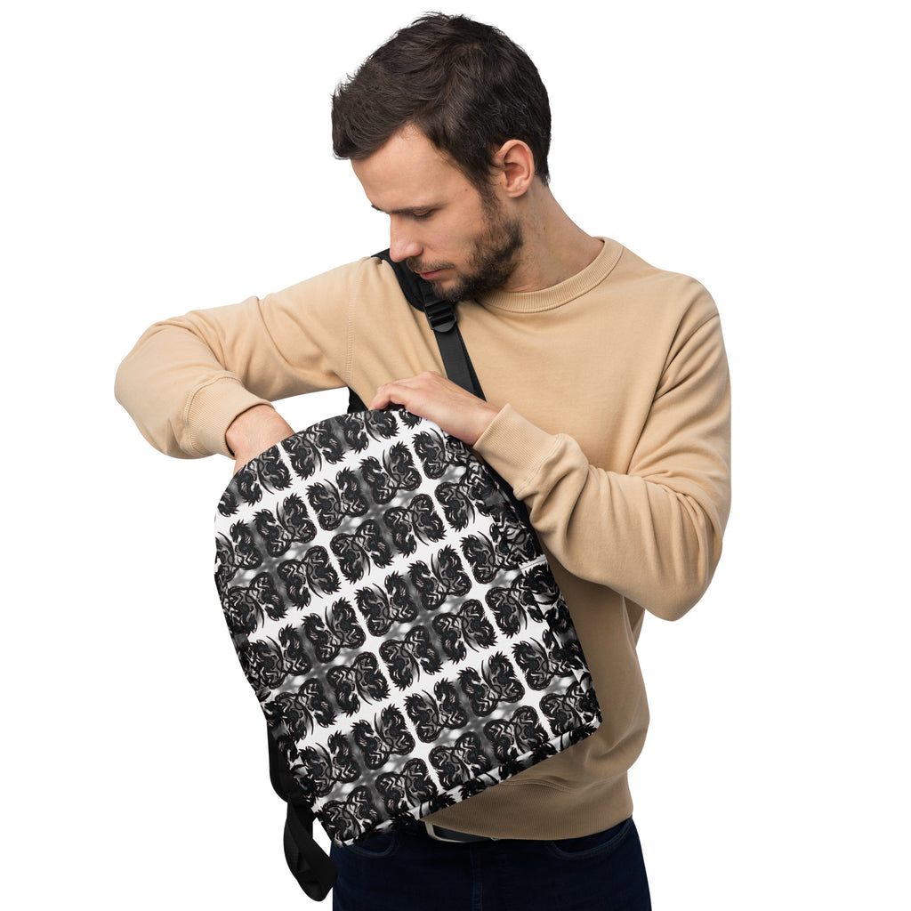 Man holding a black and white patterned backpack against a white background