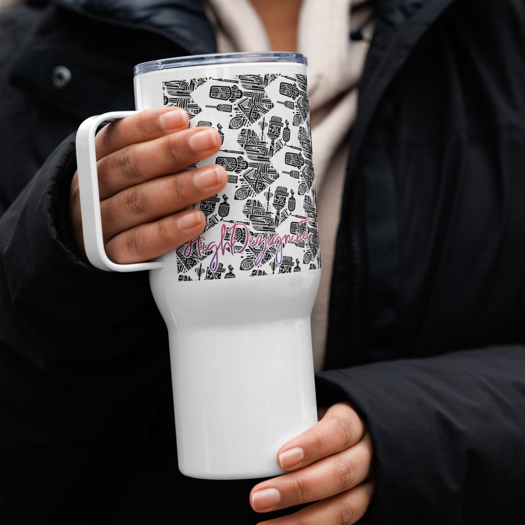 White tumbler with black and gray pattern held by a person wearing a black coat.