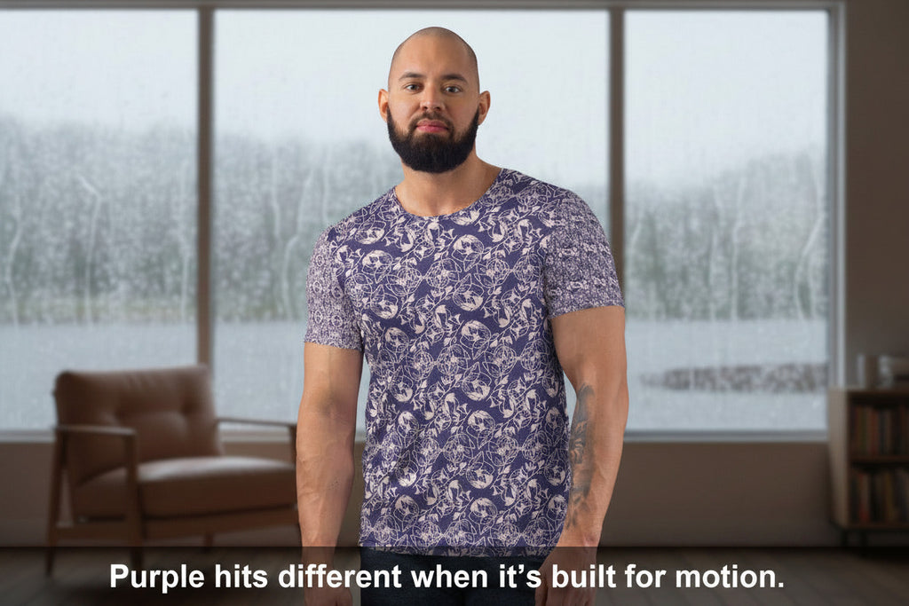 Man in a floral shirt standing in a bedroom holding a mug.