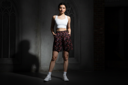 Woman in athletic wear standing in a dark room with a window.