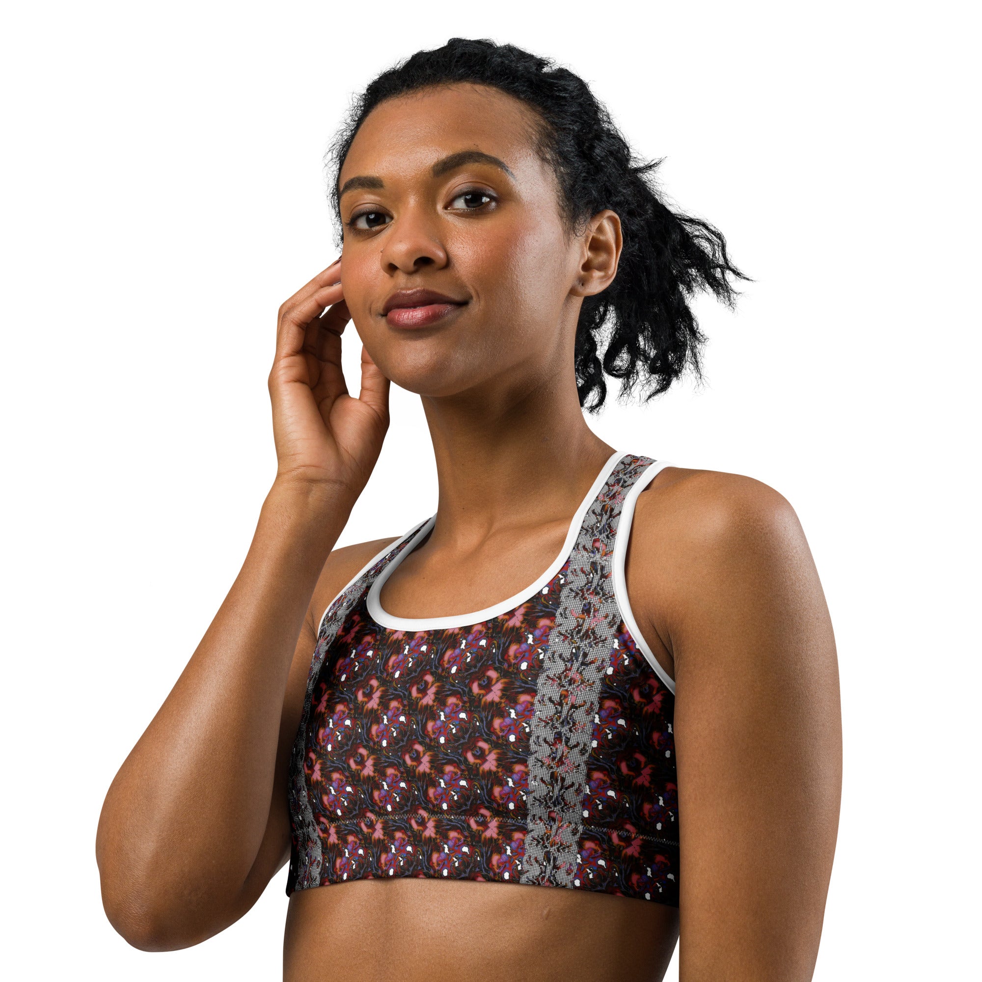 A woman wearing a patterned sports bra with white trim, photographed against a solid white background.